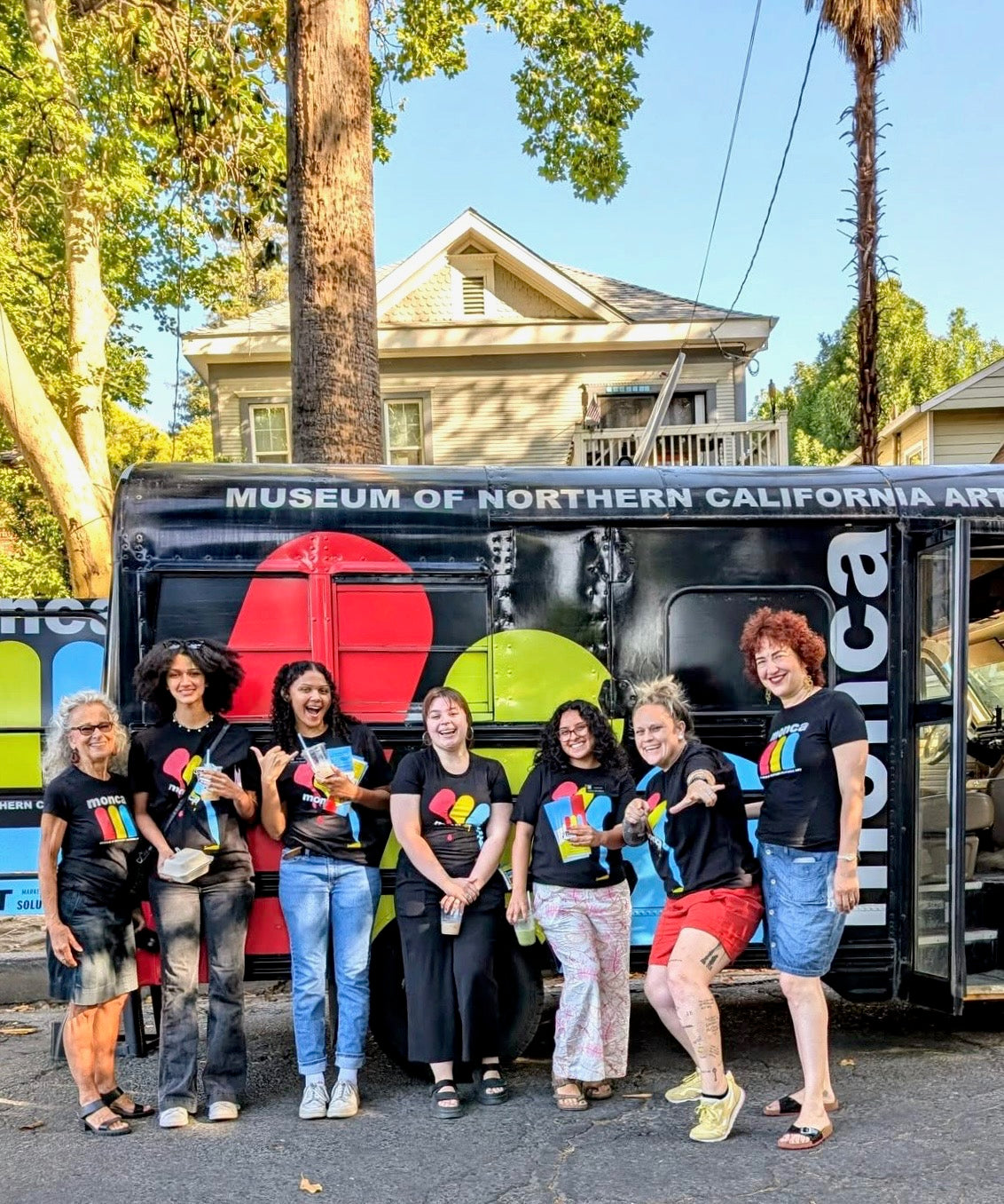 Group of people posing in front of a Museum of Northern California Art truck