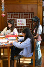 Children in a library setting with a 'Kids' Corner' sign in the background.